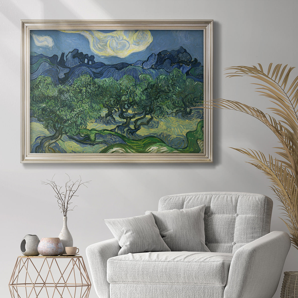 Impressionist olive grove landscape by Vincent van Gogh in an ornate champagne frame displayed in a bright interior setting.