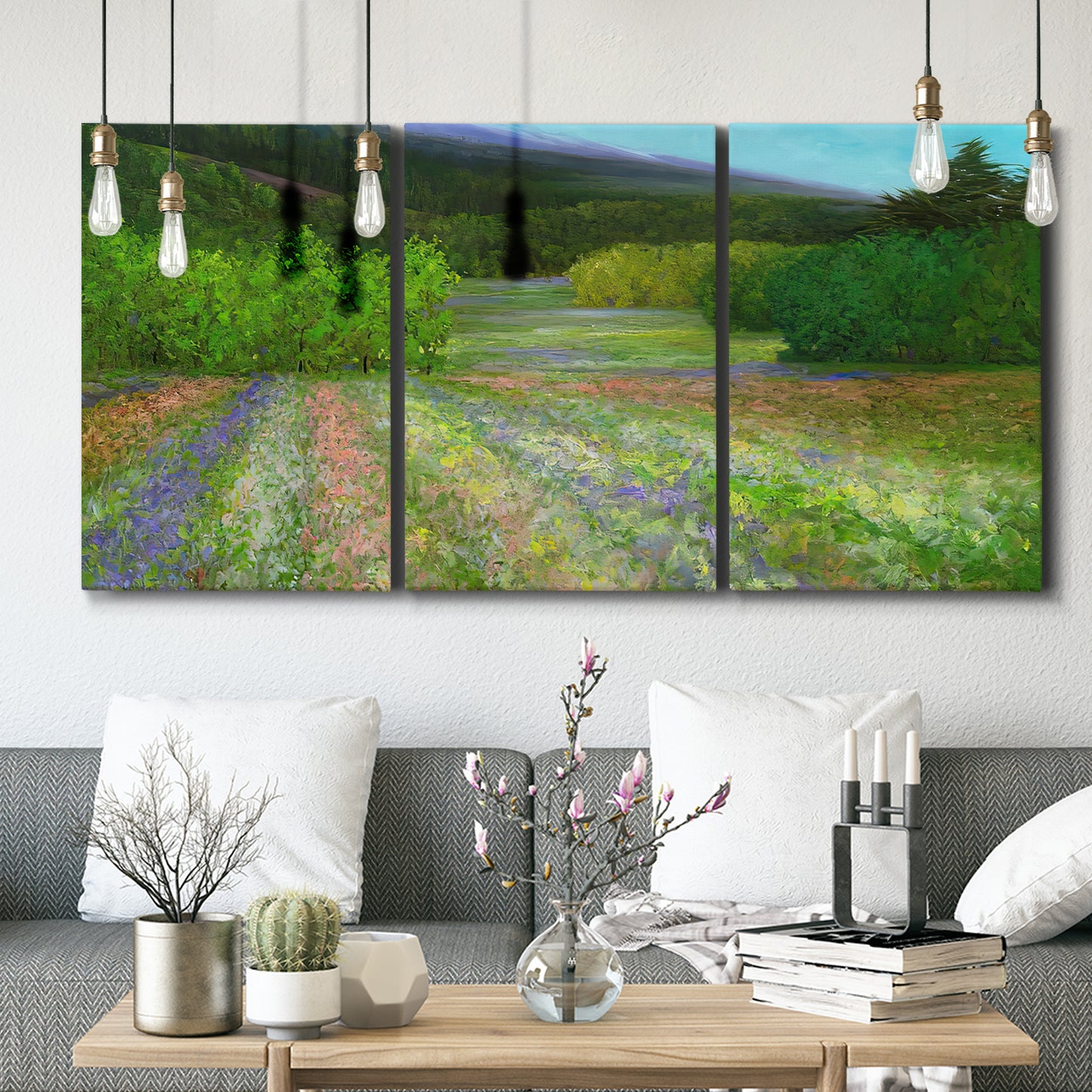 Three-panel canvas wall art featuring fresh spring meadow landscape, displayed in a modern living room above seating.