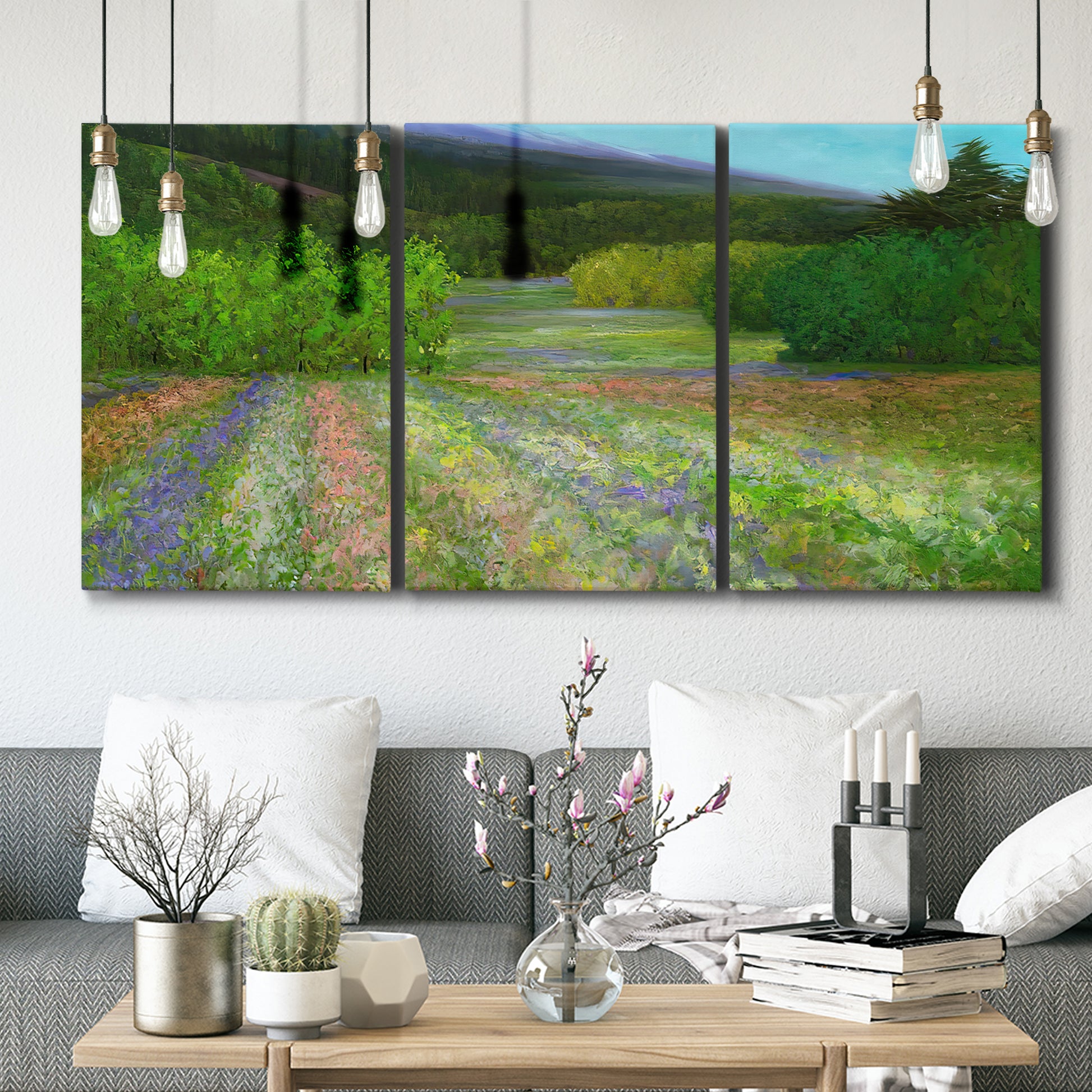 Three-panel canvas wall art featuring fresh spring meadow landscape, displayed in a modern living room above seating.