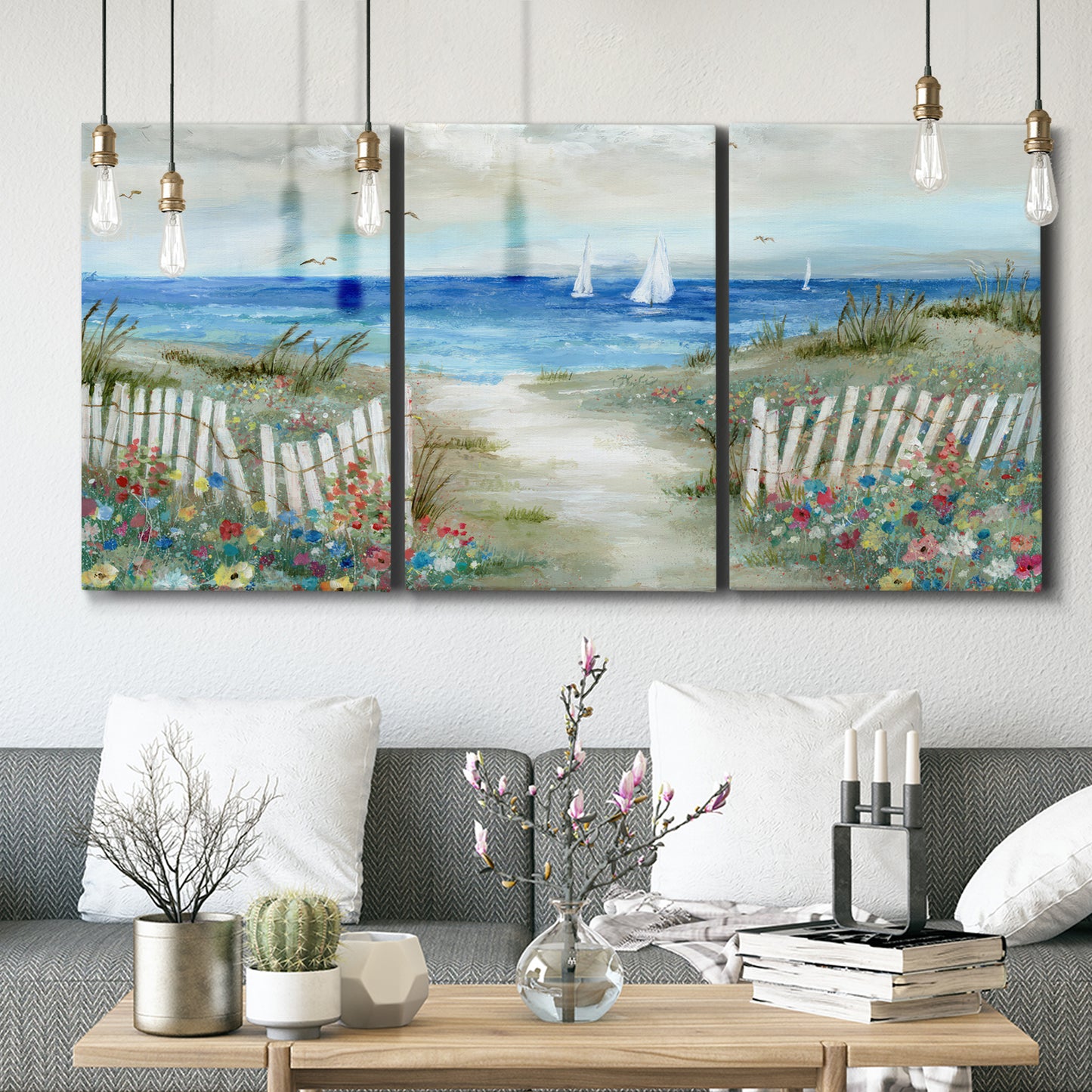 Three-panel canvas wall art featuring lush coastal garden landscape, displayed in a modern living room above seating.