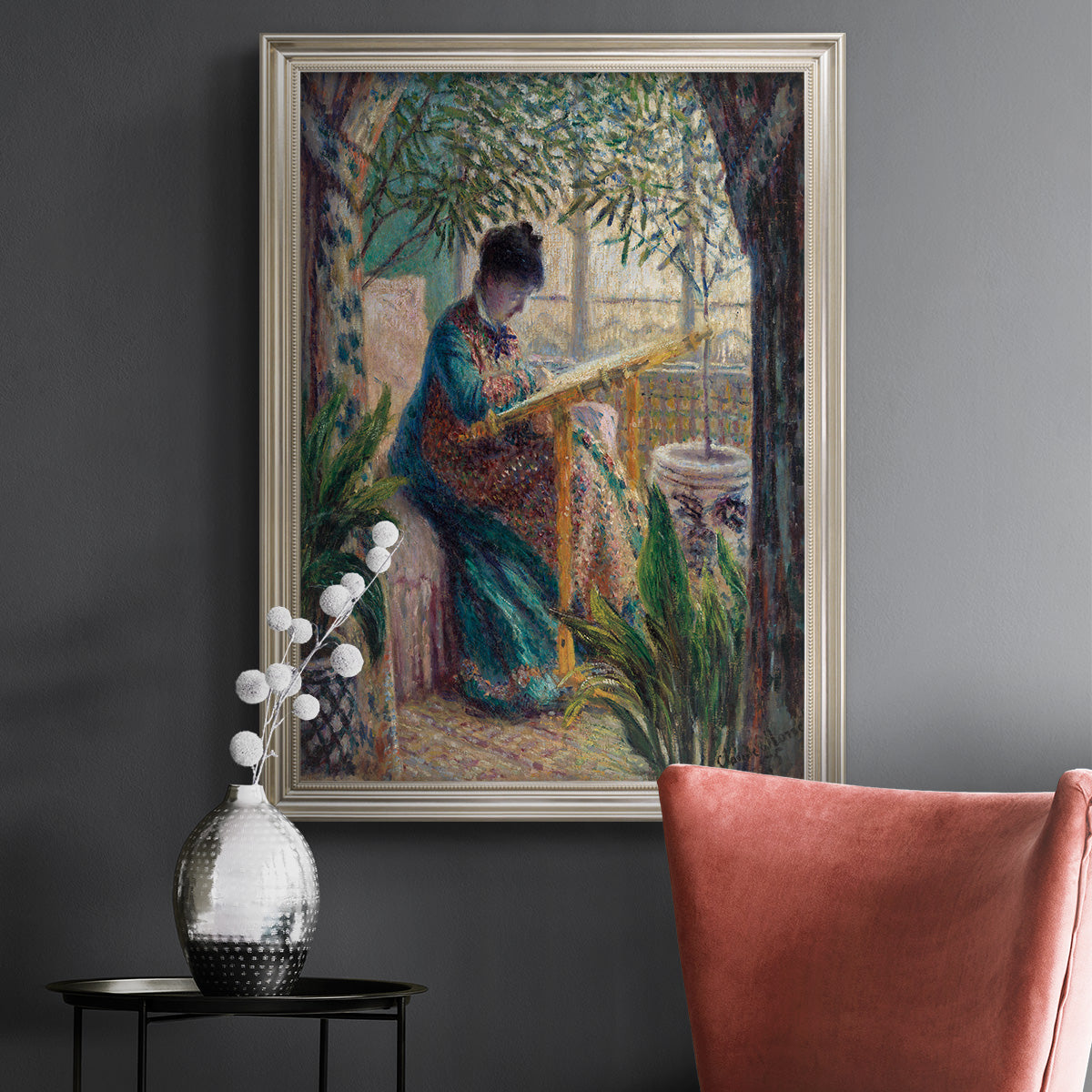 Impressionist portrait of Madame Monet sewing by Claude Monet in an ornate champagne frame displayed in a dark-toned interior setting.