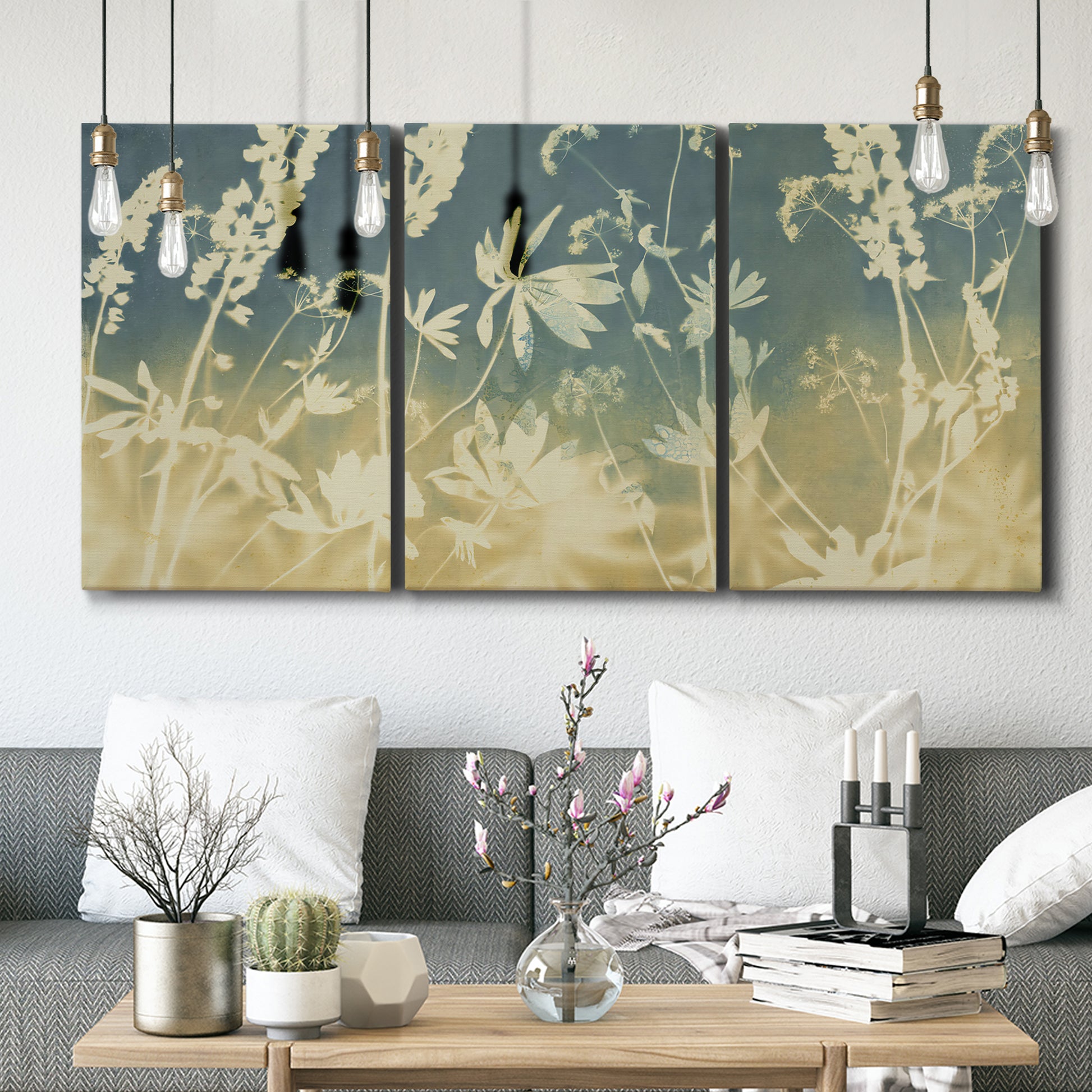 Three-panel canvas wall art featuring lupine flowers in seasonal bloom, displayed in a modern living room above seating.
