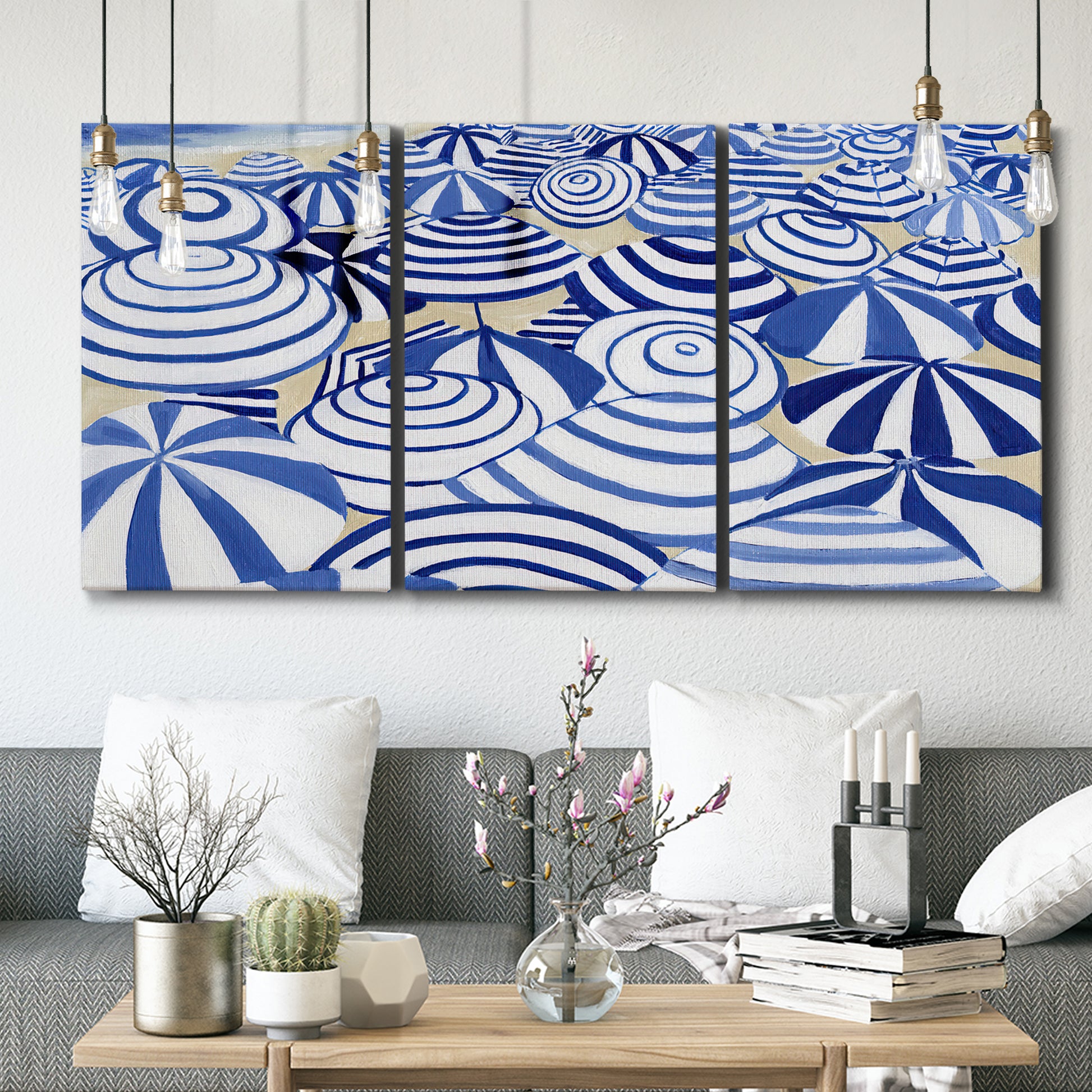 Three-panel canvas wall art featuring geometric abstract bowl forms, displayed in a modern living room above seating.