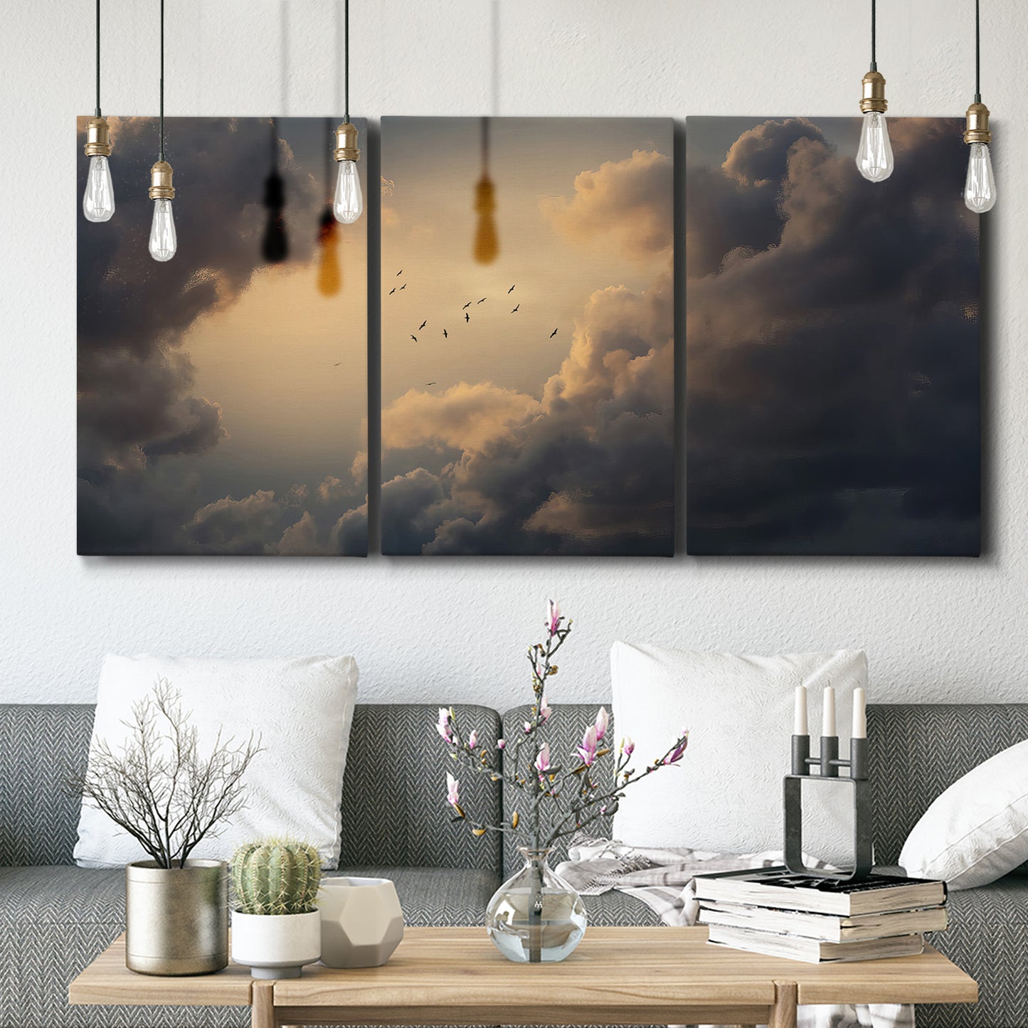Three-panel canvas wall art featuring surreal floating figures above landscape, displayed in a modern living room above seating.