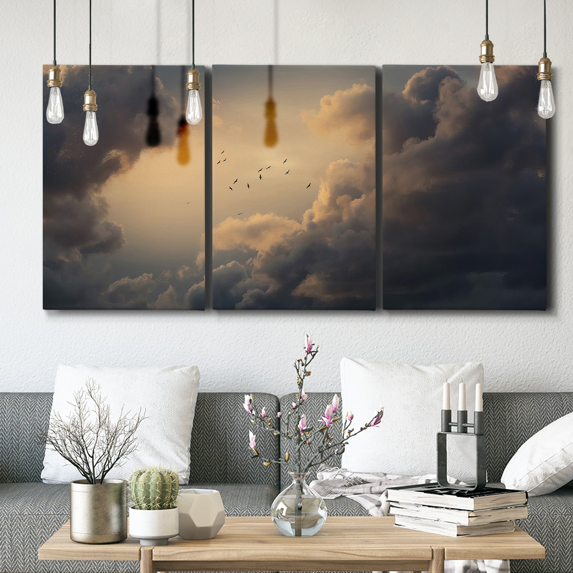 Three-panel canvas wall art featuring surreal floating figures above landscape, displayed in a modern living room above seating.