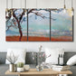 Three-panel canvas wall art featuring coastal trees at evening light, displayed in a modern living room above seating.
