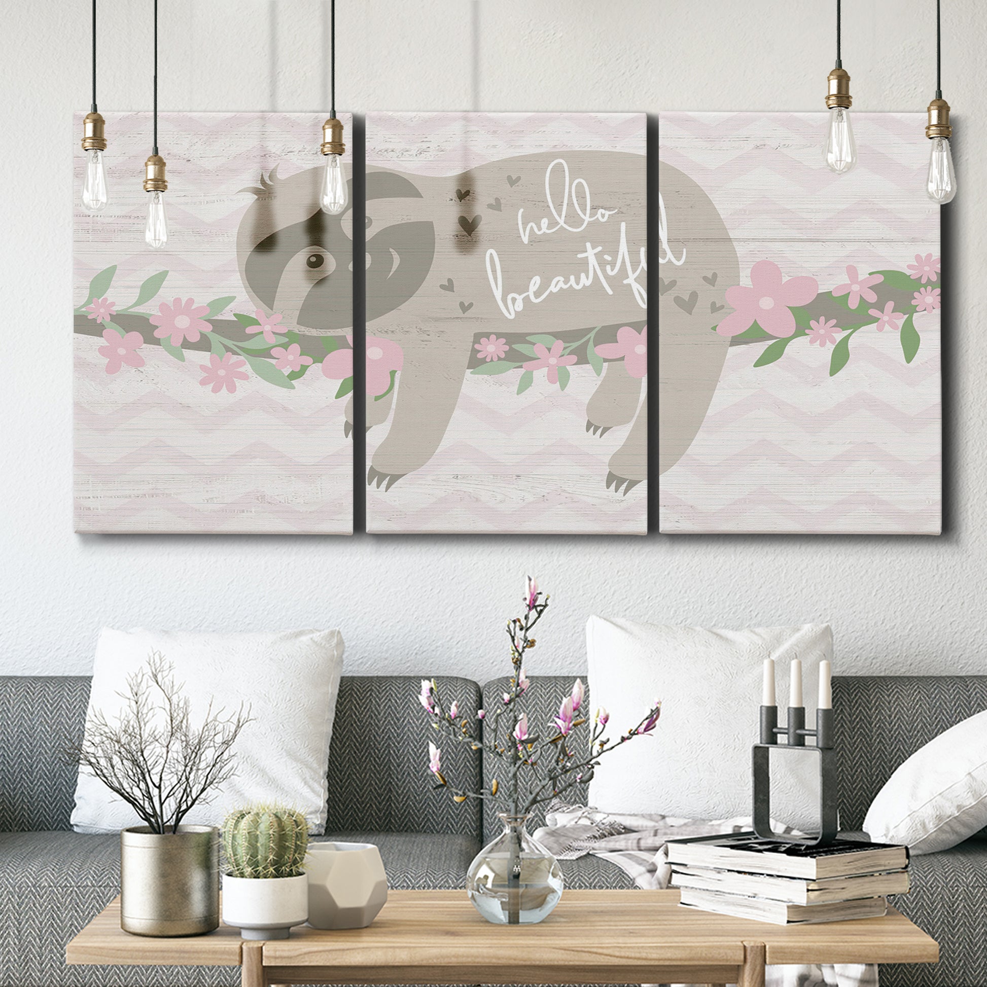 Three-panel canvas wall art featuring sloth with floral decorative elements, displayed in a modern living room above seating.