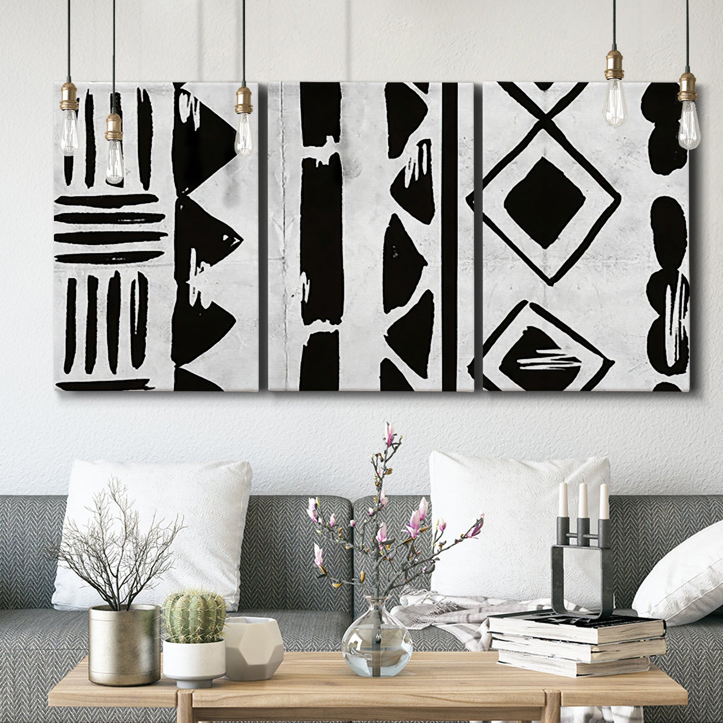 Three-panel canvas wall art featuring geometric abstract forms merging pattern, displayed in a modern living room above seating.