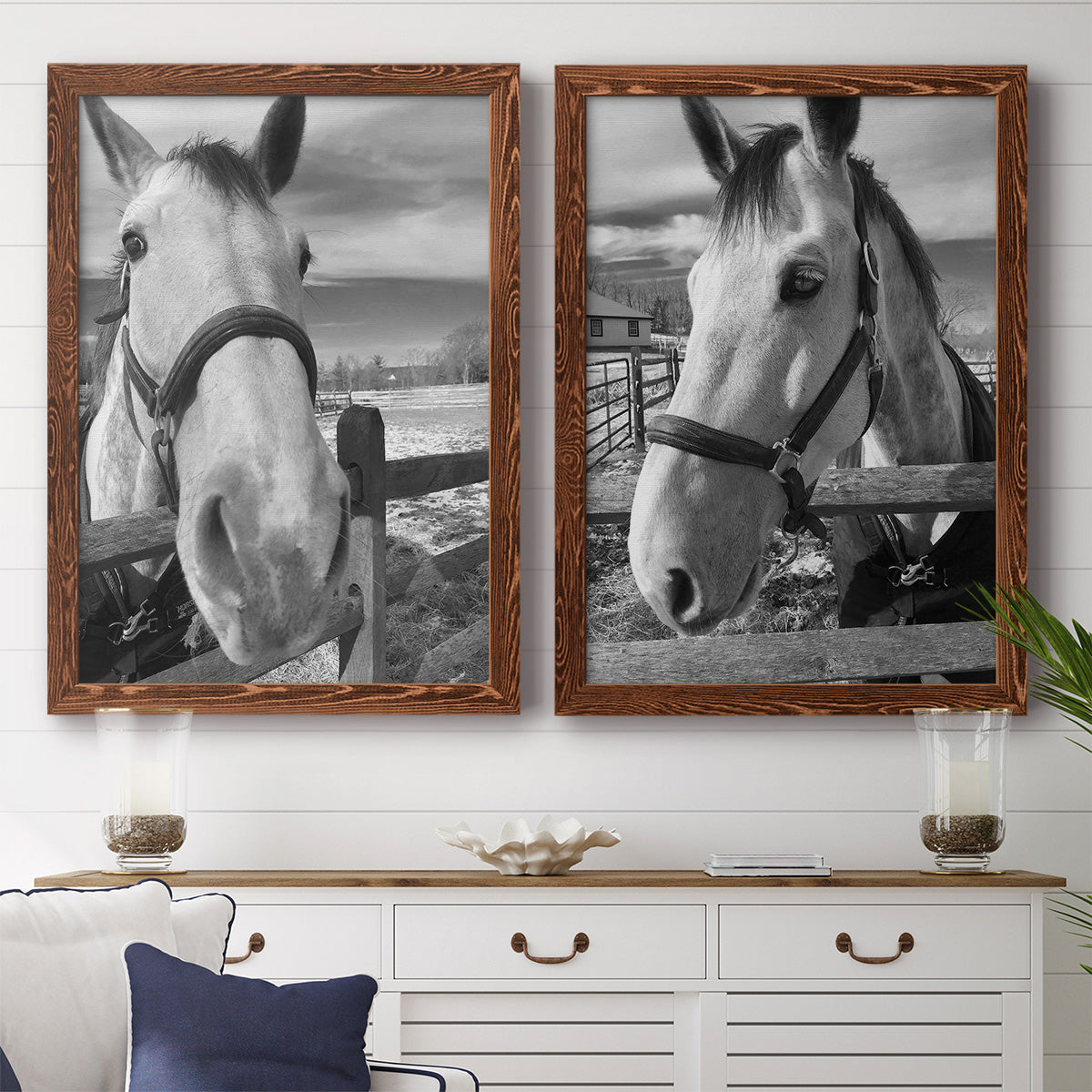 Set of two maple barnwood framed canvas prints depicting a coordinated art pair of black-and-white close-up portraits of horses at fences rendered as modern equestrian photography above a dining room sideboard.