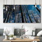 Three-panel canvas wall art featuring night landscape silhouette photography, displayed in a modern living room above seating.