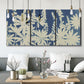 Three-panel canvas wall art featuring delicate lupine floral composition, displayed in a modern living room above seating.