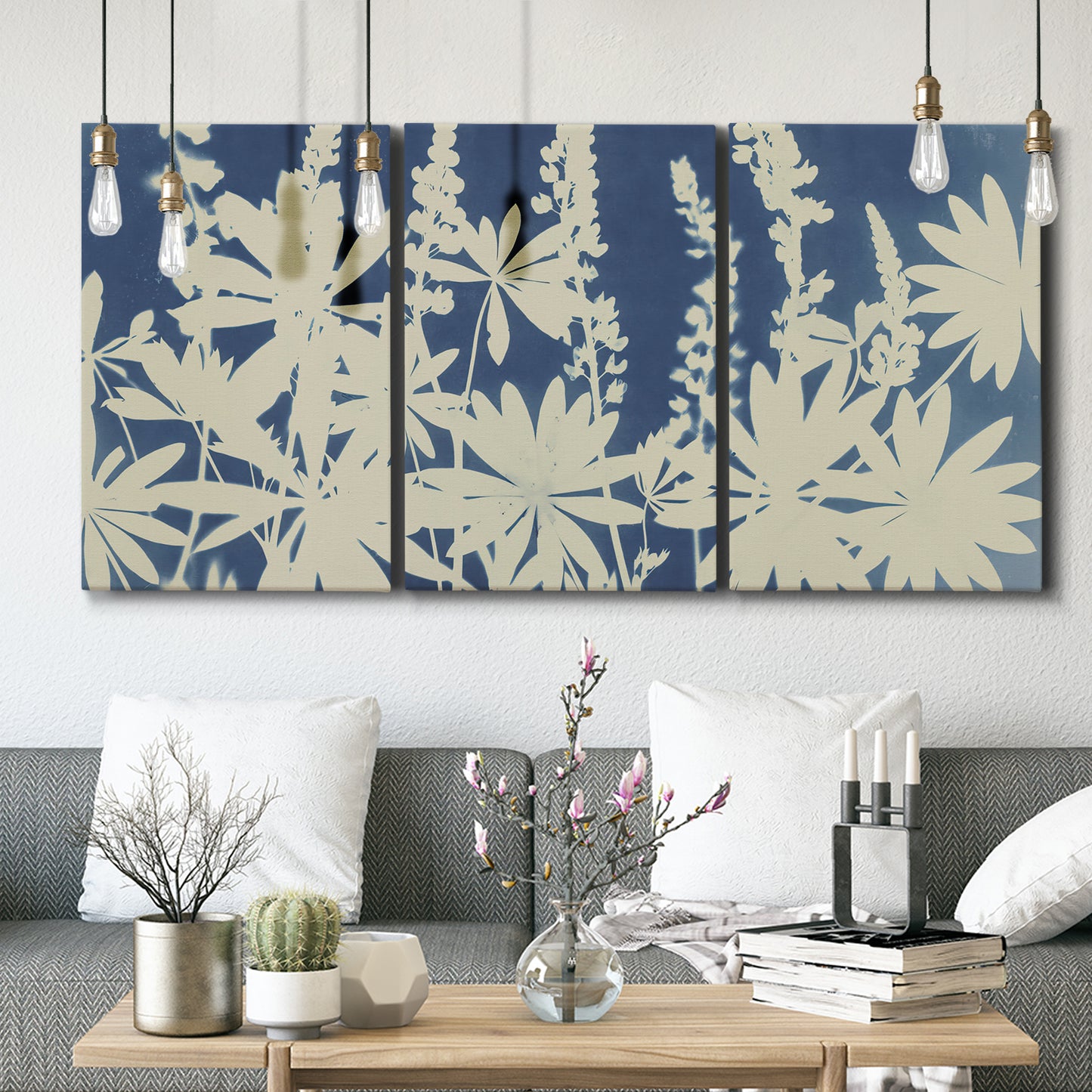 Three-panel canvas wall art featuring delicate lupine floral composition, displayed in a modern living room above seating.