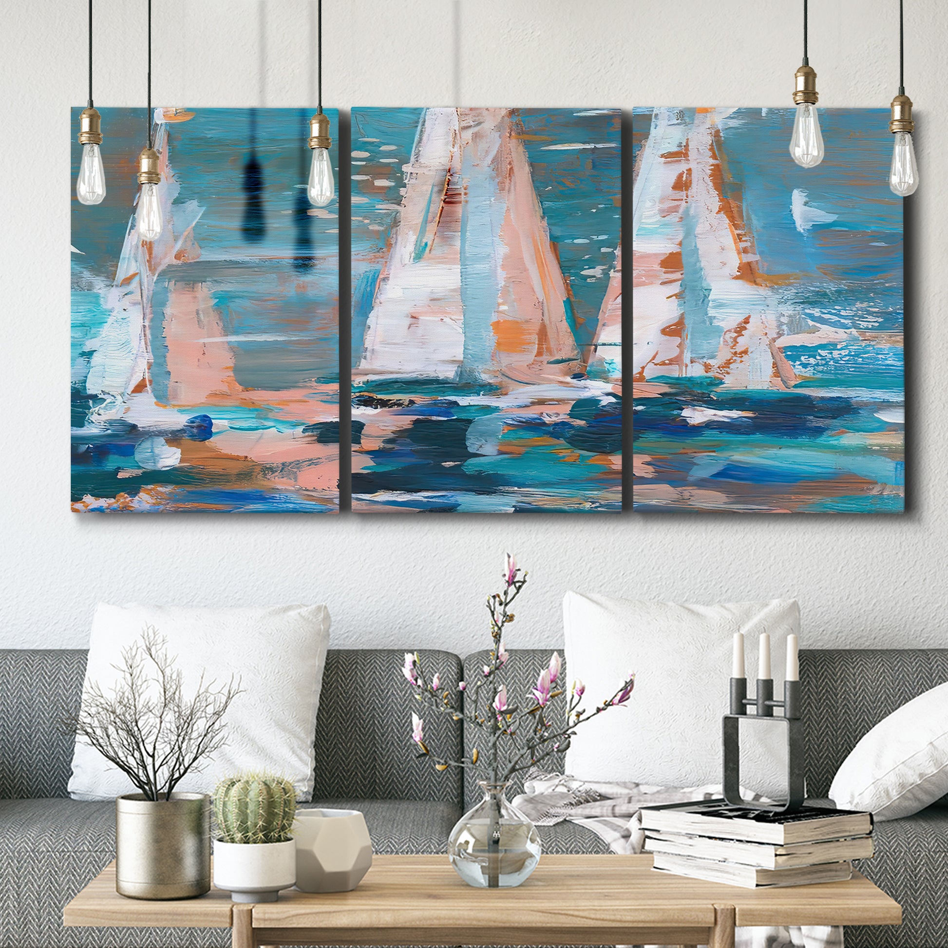 Three-panel canvas wall art featuring graphic pop style sailboats, displayed in a modern living room above seating.