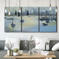 Three-panel canvas wall art featuring anchored boats near shoreline, displayed in a modern living room above seating.