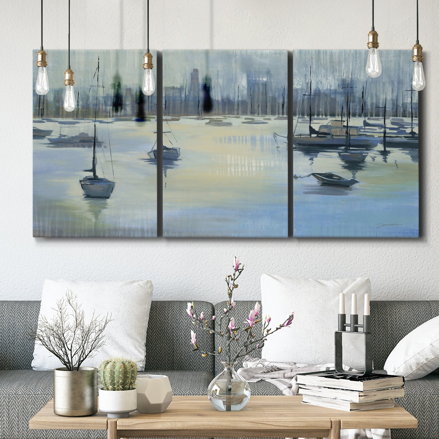 Three-panel canvas wall art featuring anchored boats near shoreline, displayed in a modern living room above seating.