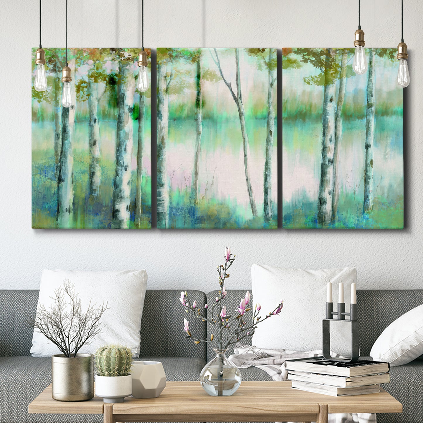 Three-panel canvas wall art featuring calm lake framed by aspen trees, displayed in a modern living room above seating.