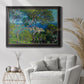 Impressionist Mediterranean coastal landscape by Claude Monet in an ornate black frame with gilded inner detail displayed in a bright interior setting.