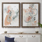 Set of two walnut barnwood framed canvas prints depicting a coordinated art pair of loose blush gray and coral floral gestures rendered as abstract watercolor botanicals above a dining room sideboard.