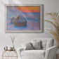 Impressionist haystack scene at sunset by Claude Monet in an ornate weathered white frame displayed in a bright interior setting.