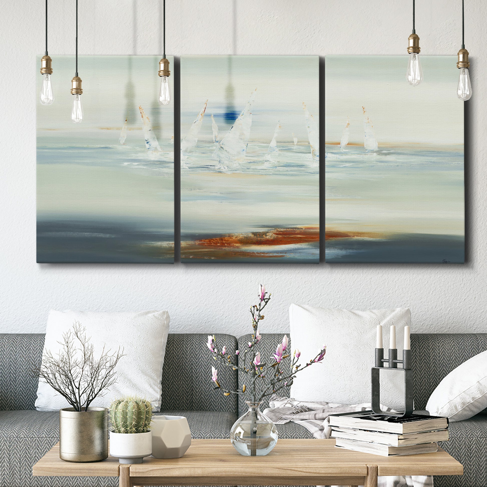 Three-panel canvas wall art featuring nautical abstract suggesting drifting calm, displayed in a modern living room above seating.