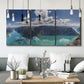 Three-panel canvas wall art featuring tropical water reflections with foliage, displayed in a modern living room above seating.