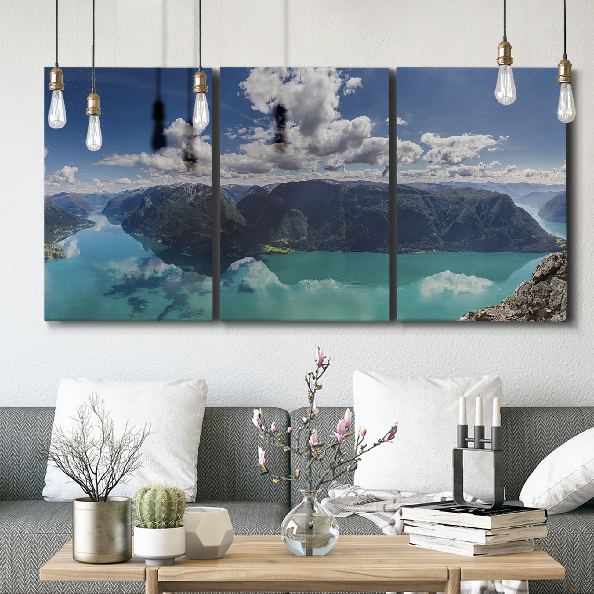 Three-panel canvas wall art featuring tropical water reflections with foliage, displayed in a modern living room above seating.
