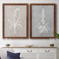 Set of two maple barnwood framed canvas prints depicting a coordinated art pair of white botanical silhouettes on softly weathered neutral backgrounds rendered as rustic minimalist botanical prints above a dining room sideboard.