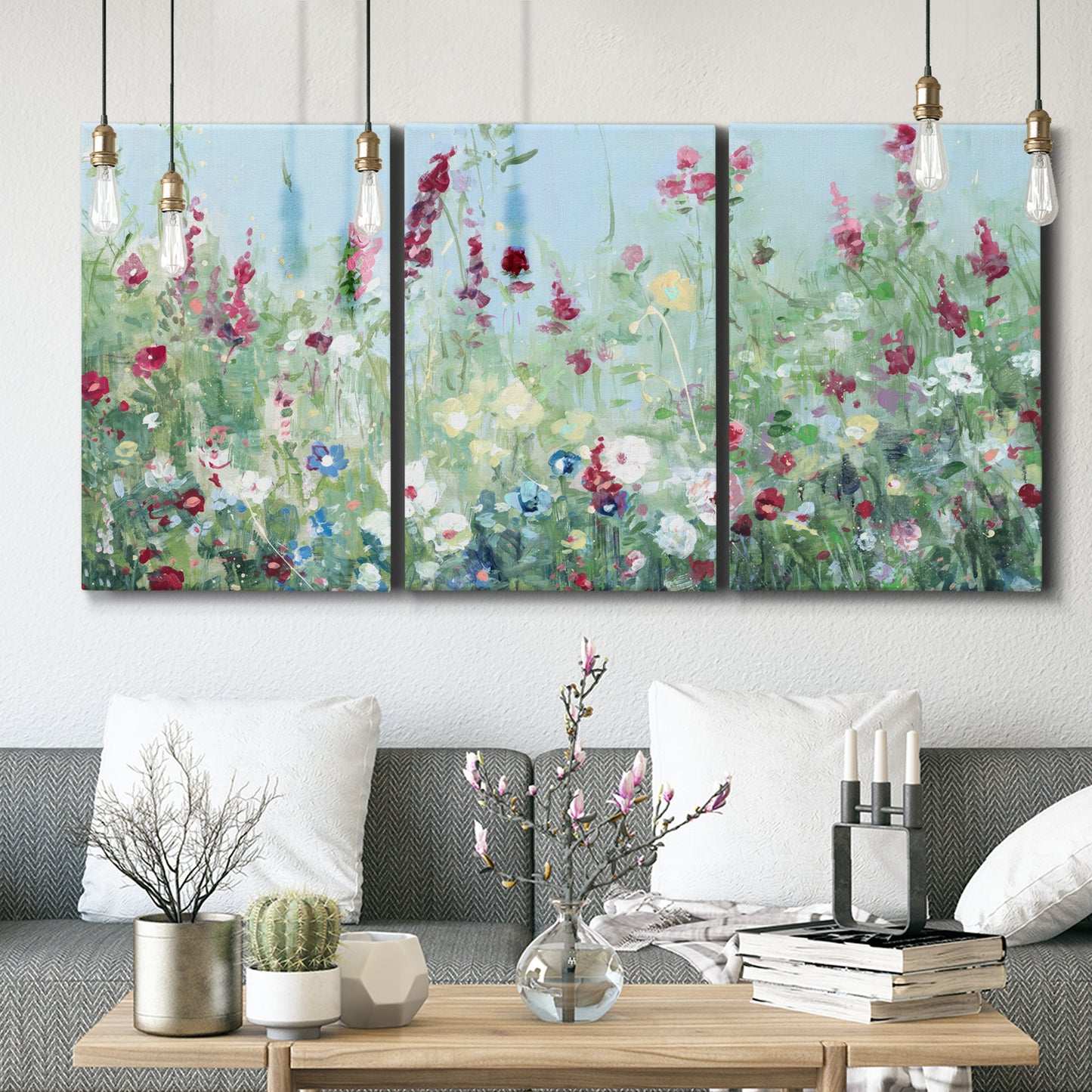 Three-panel canvas wall art featuring night landscape silhouette photography, displayed in a modern living room above seating.