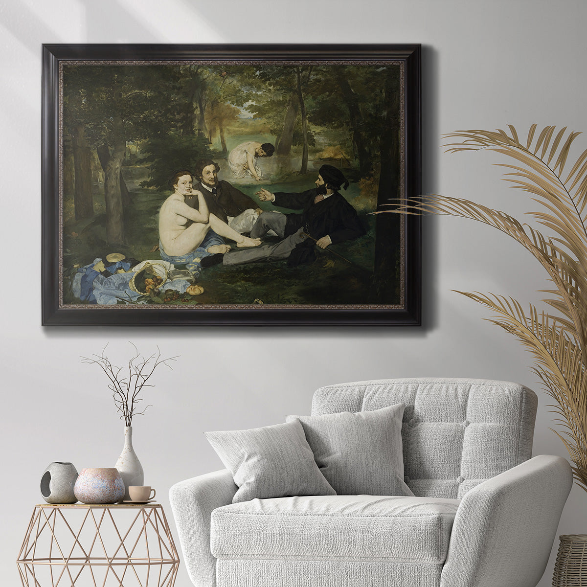 Groundbreaking impressionist picnic scene by Édouard Manet in an ornate black frame with gilded inner detail displayed in a bright interior setting.