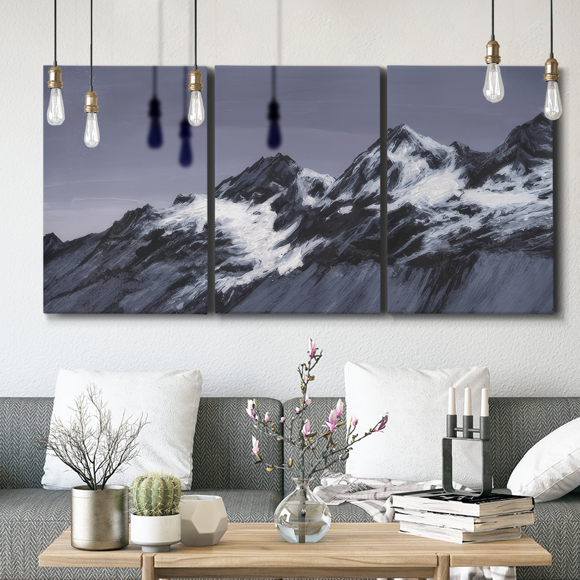 Three-panel canvas wall art featuring moonlit mountain peaks under night sky, displayed in a modern living room above seating.