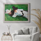 Impressionist outdoor portrait of two girls by John Singer Sargent in an ornate weathered white frame displayed in a bright interior setting.