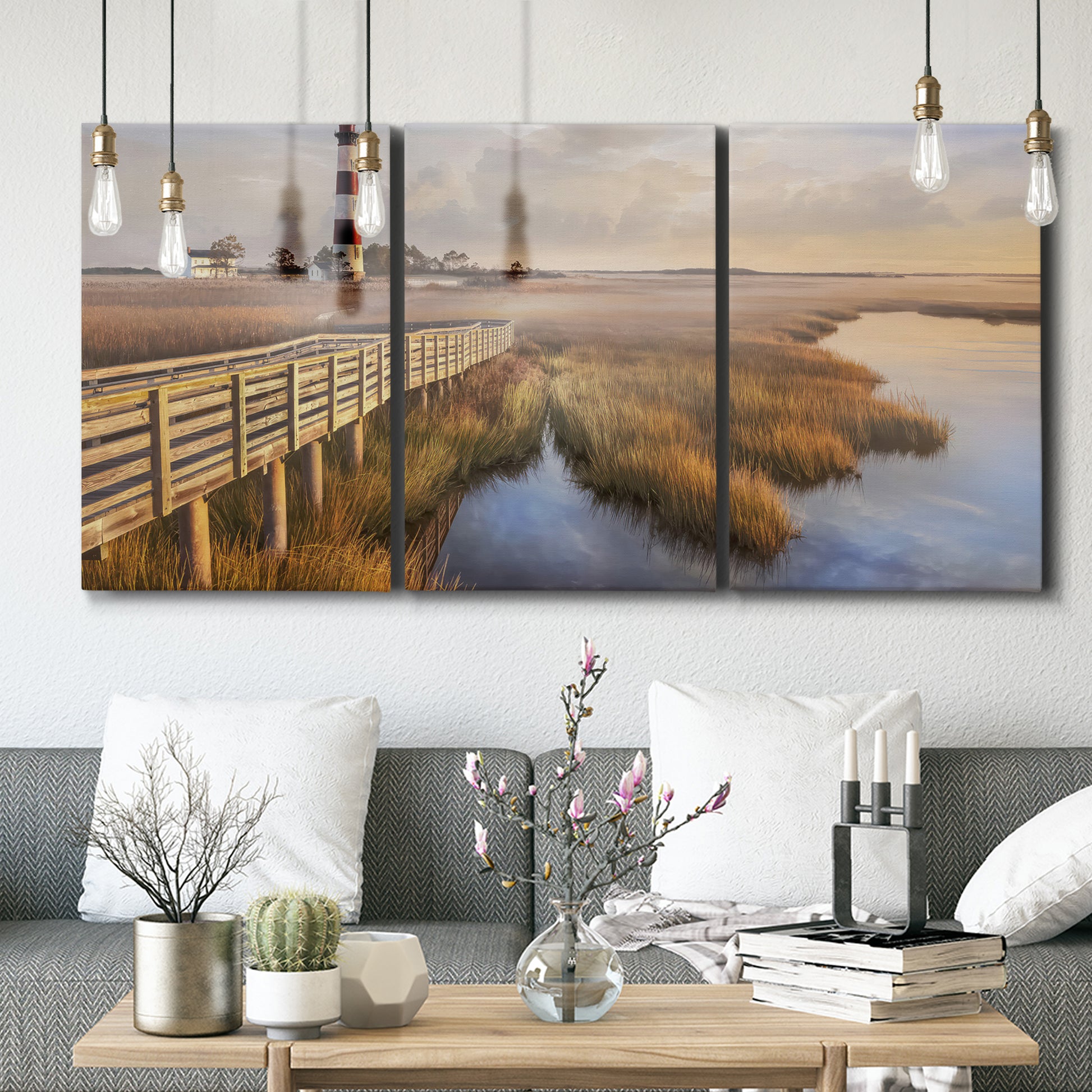 Three-panel canvas wall art featuring coastal path along dunes, displayed in a modern living room above seating.