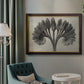 Vintage botanical plant study photograph by Karl Blossfeldt in an ornate mahogany wood frame with gold liner displayed in a neutral interior setting.