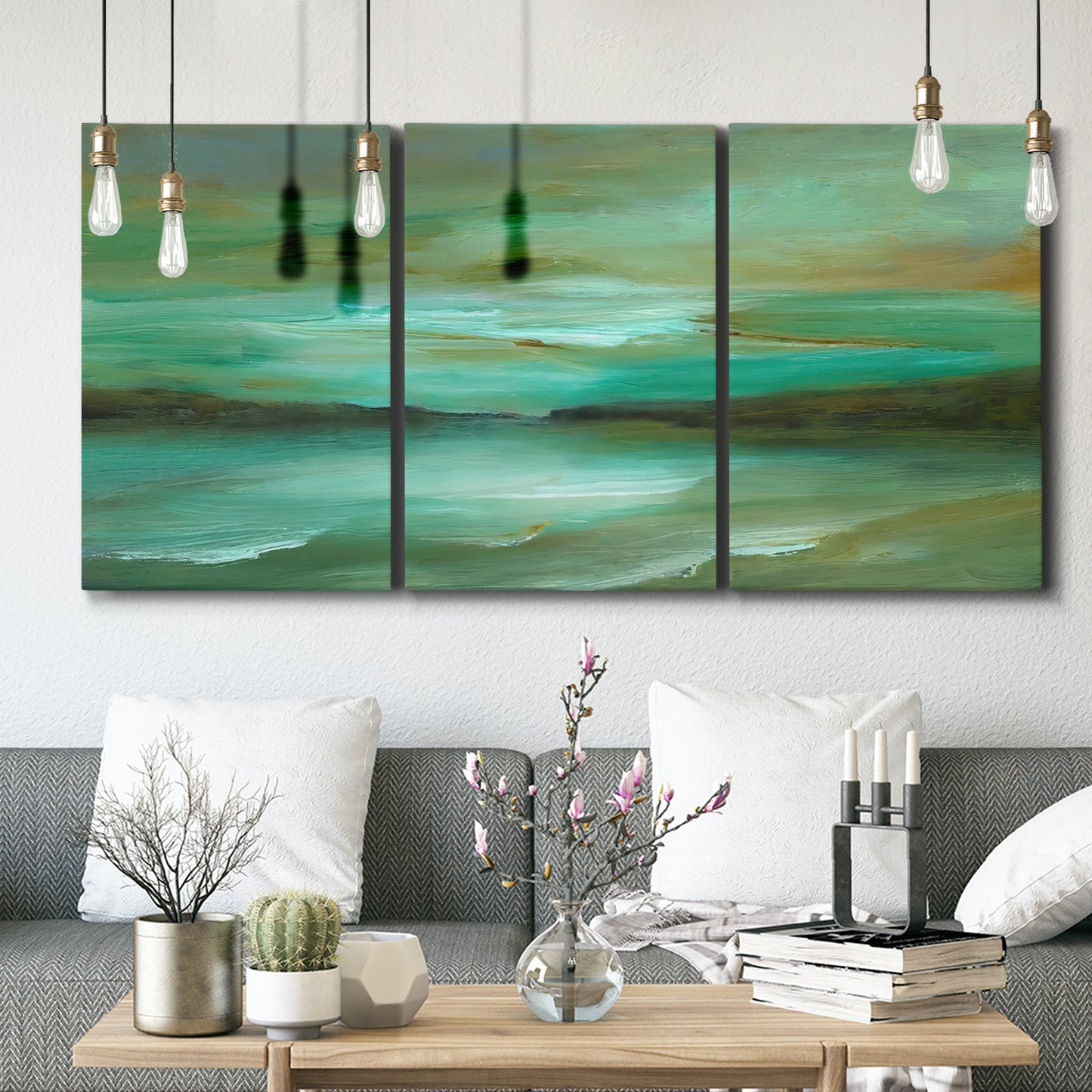 Three-panel canvas wall art featuring hidden coastal cove landscape, displayed in a modern living room above seating.