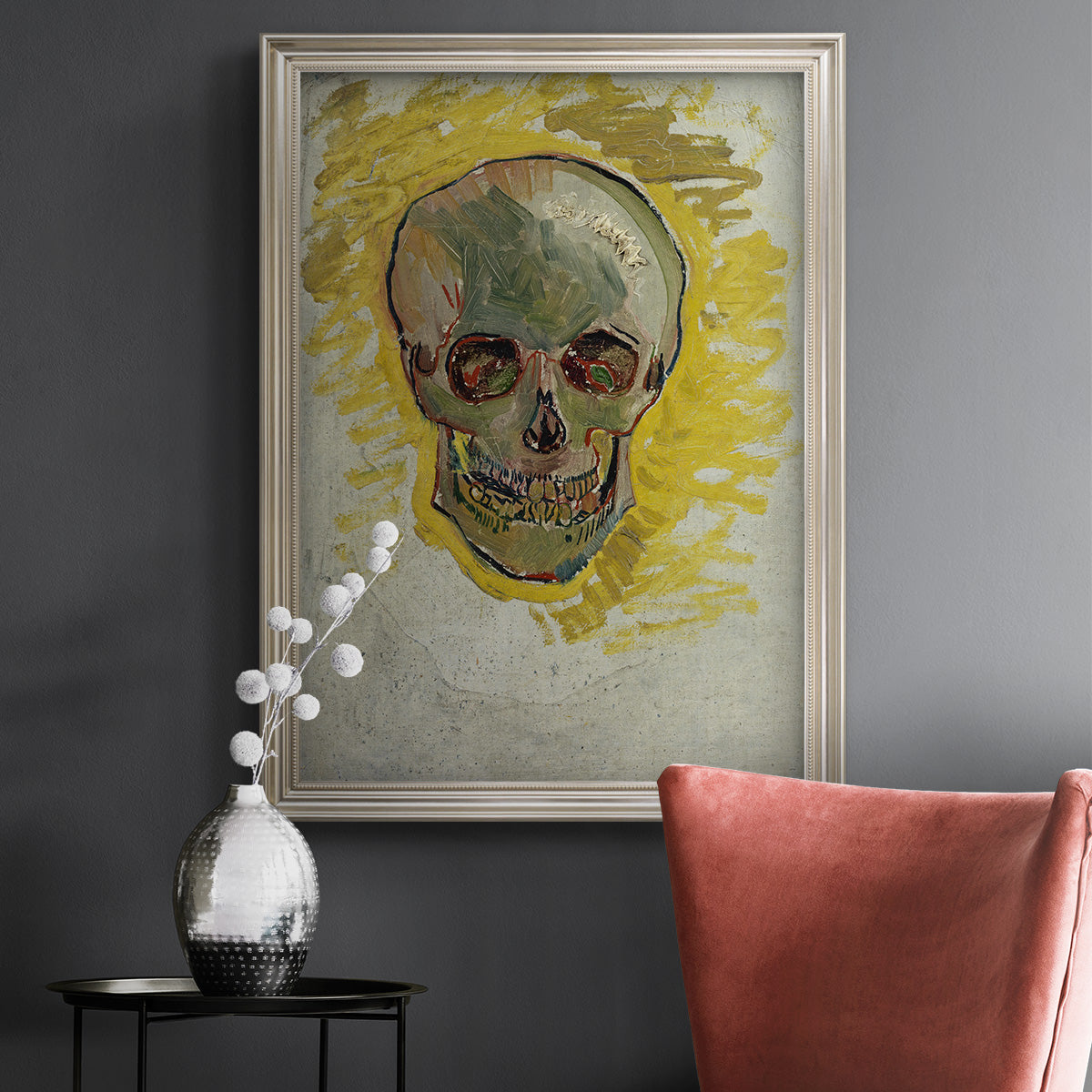 Expressive skull study painting by Vincent van Gogh in an ornate champagne frame displayed in a dark-toned interior setting.