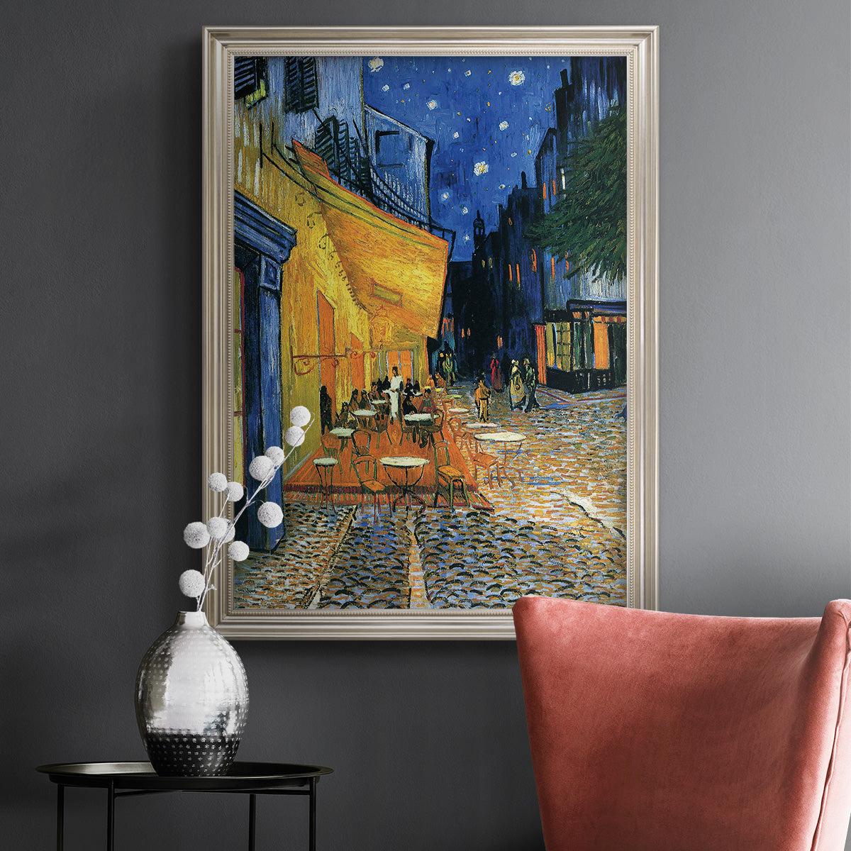 Impressionist night café street scene by Vincent van Gogh in an ornate champagne frame displayed in a dark-toned interior setting.