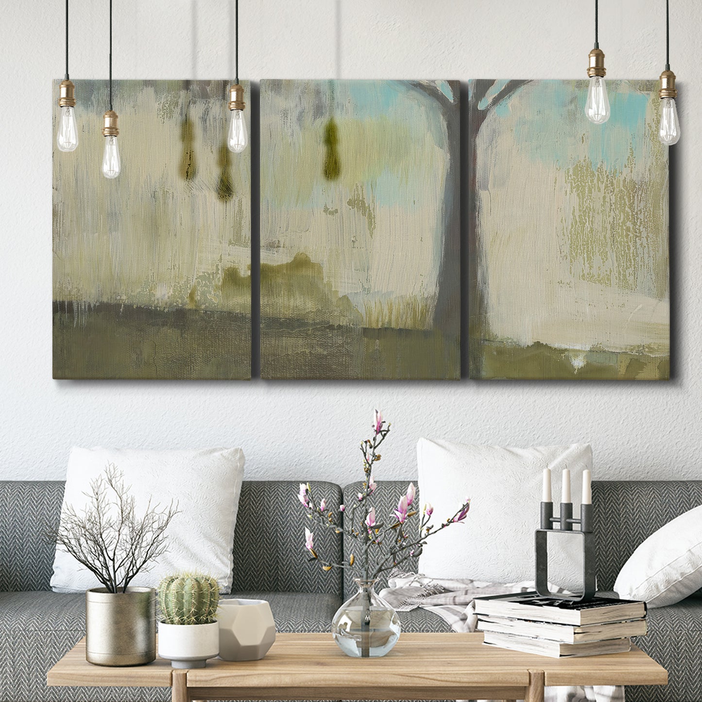 Three-panel canvas wall art featuring tall abstract tree form, displayed in a modern living room above seating.