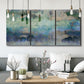 Three-panel canvas wall art featuring cool dreamy abstraction, displayed in a modern living room above seating.