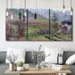 Three-panel canvas wall art featuring cliffside cottage overlooking sea, displayed in a modern living room above seating.