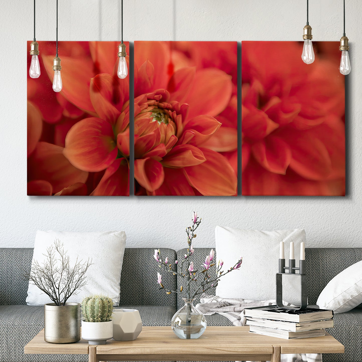 Three-panel canvas wall art featuring vivid red floral close up, displayed in a modern living room above seating.