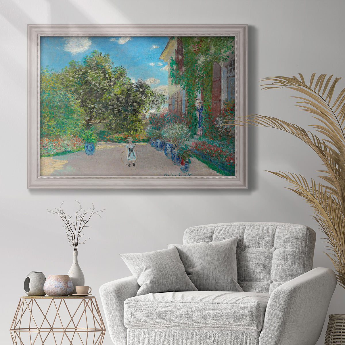 Impressionist residential landscape at Argenteuil by Claude Monet in an ornate weathered white frame displayed in a bright interior setting.