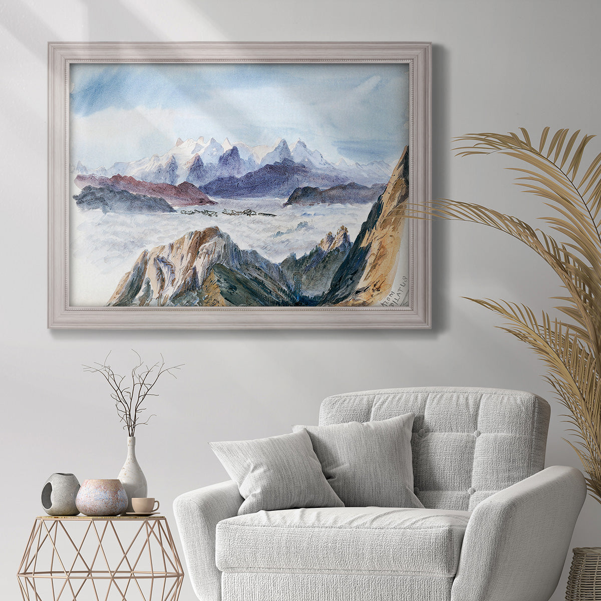 Impressionist alpine mountain landscape by John Singer Sargent in an ornate weathered white frame displayed in a bright interior setting.