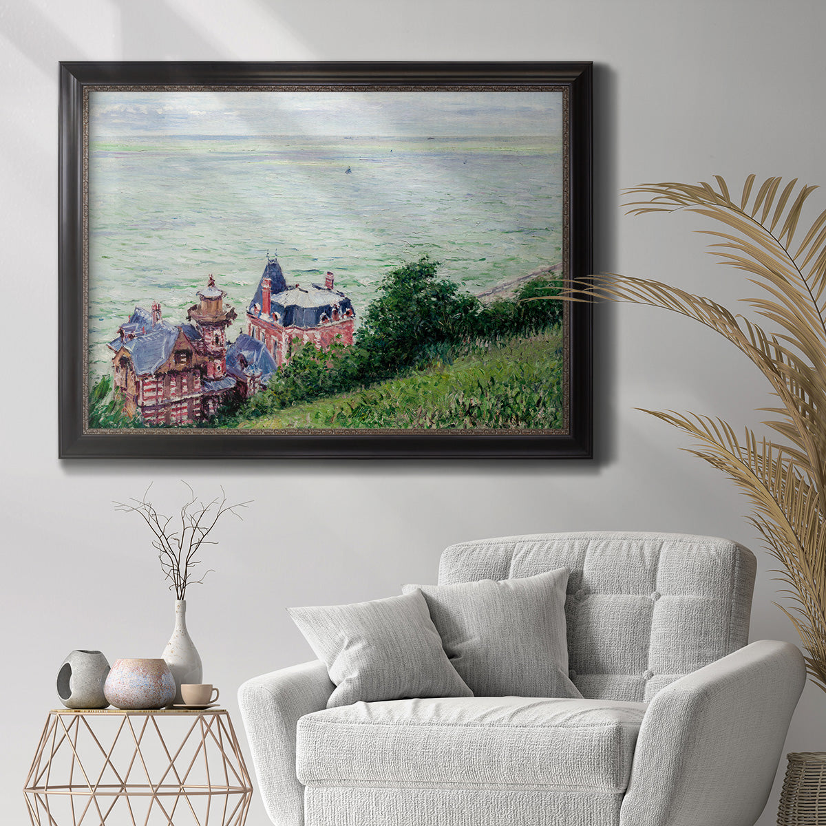 Impressionist coastal villas landscape by Gustave Caillebotte in an ornate black frame with gilded inner detail displayed in a bright interior setting.
