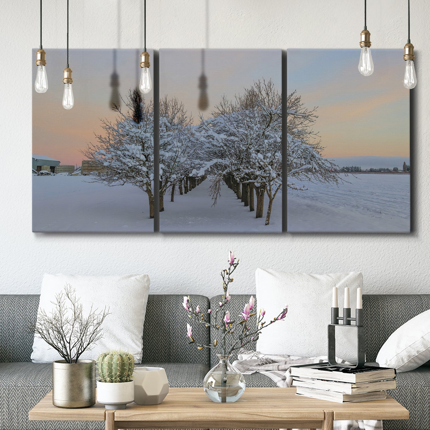Three-panel canvas wall art featuring animals among snowy woodland trees, displayed in a modern living room above seating.
