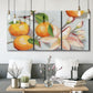 Three-panel canvas wall art featuring bright tangerine still life blossoms, displayed in a modern living room above seating.