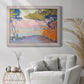 Pointillist coastal seascape by Paul Signac in an ornate weathered white frame displayed in a bright interior setting.