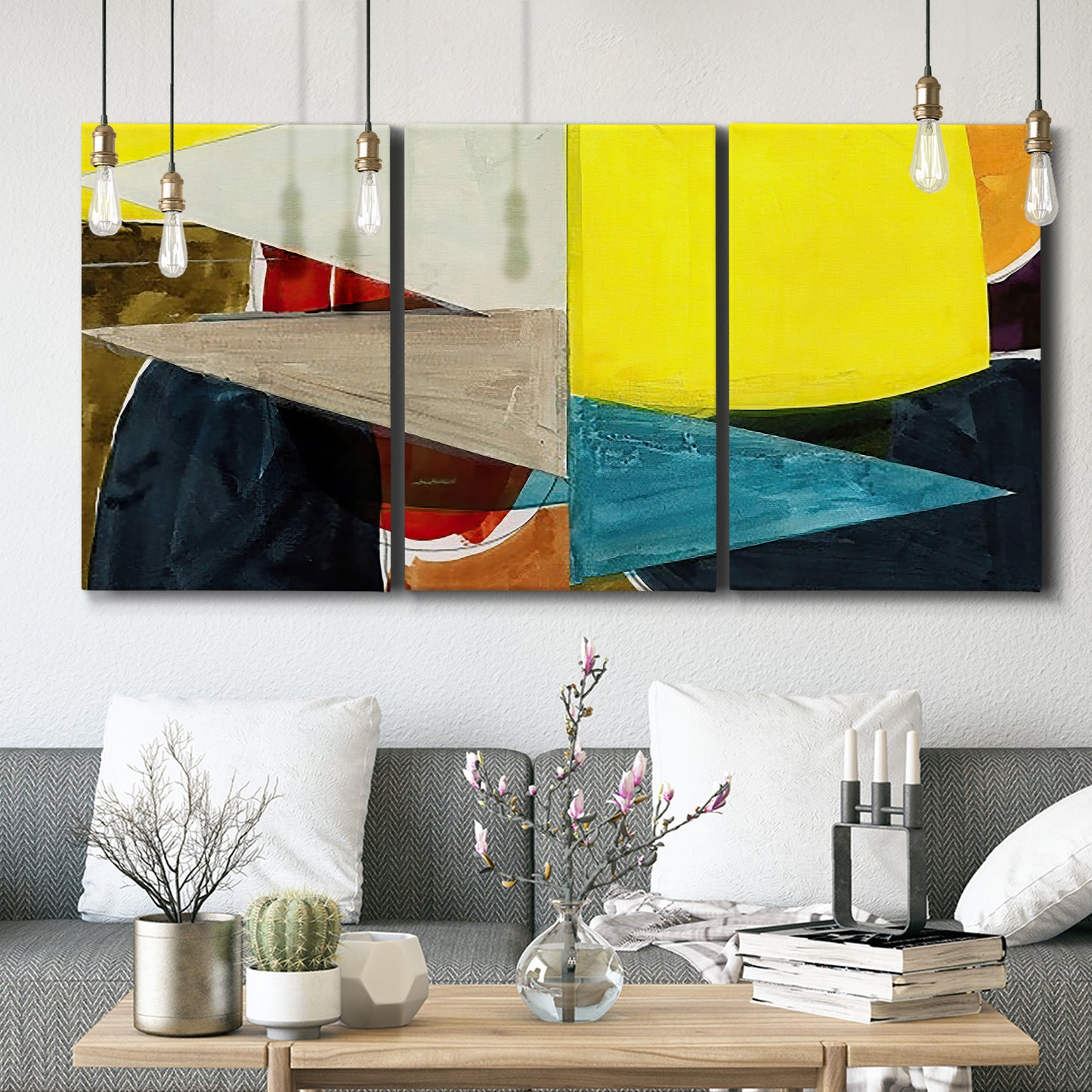 Three-panel canvas wall art featuring geometric mid century abstract blocks, displayed in a modern living room above seating.
