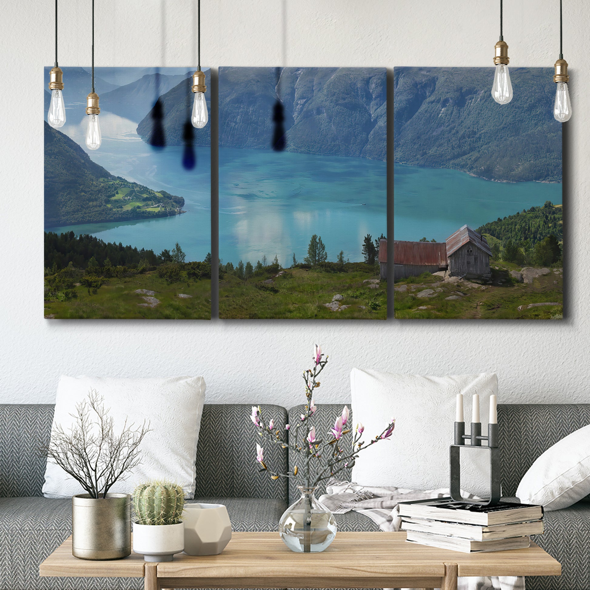 Three-panel canvas wall art featuring symmetrical water reflections with trees, displayed in a modern living room above seating.