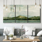Three-panel canvas wall art featuring riverbank watercolor landscape, displayed in a modern living room above seating.