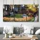 Three-panel canvas wall art featuring garden in full bloom by coast, displayed in a modern living room above seating.